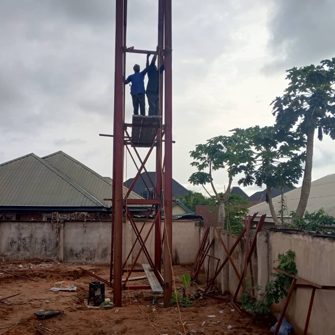 Technician climbing a steel telecom tower
